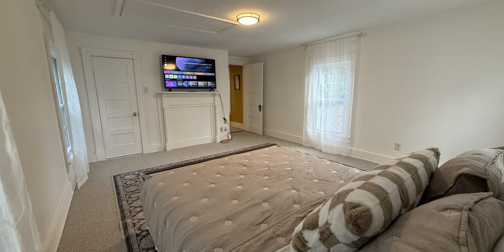Spacious bedroom with large bed at Blooming Farm